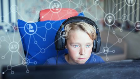 Child using computer with background visualisation of social networks