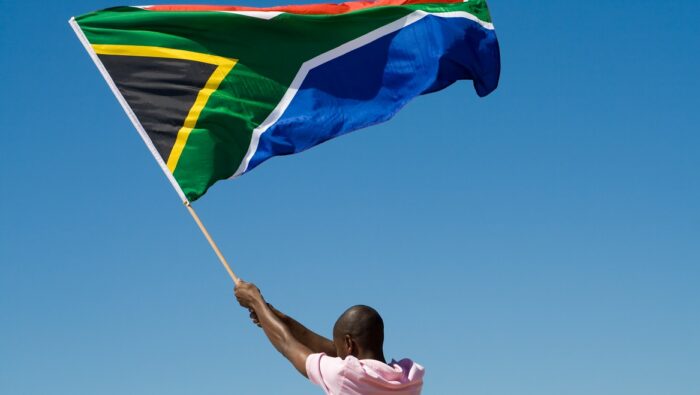 Person waving South African flag
